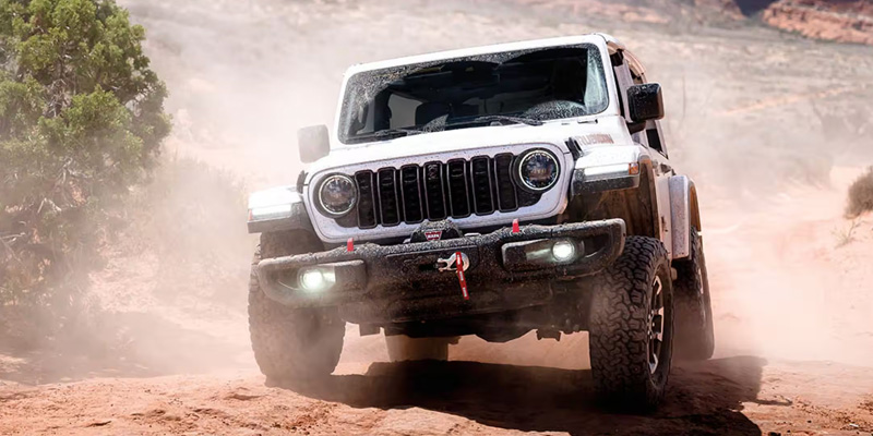 2026 Jeep® Wrangler driving on an off-road trail.