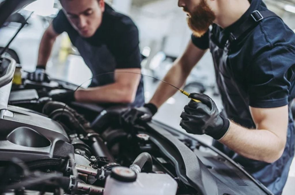 Jeep service technicians checking fluids